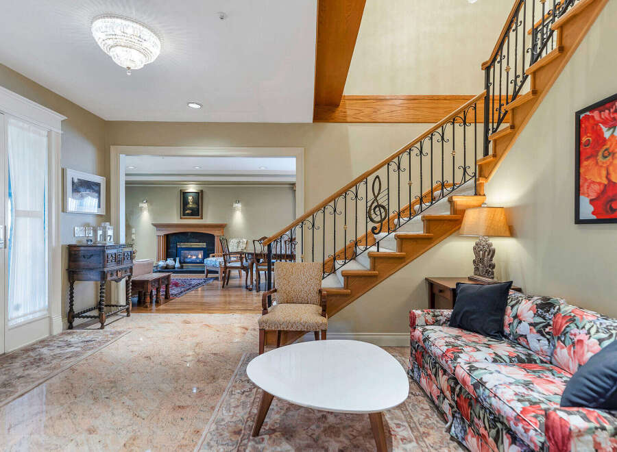 Step into luxury with this stunning property, featuring a grand staircase and elegant design.