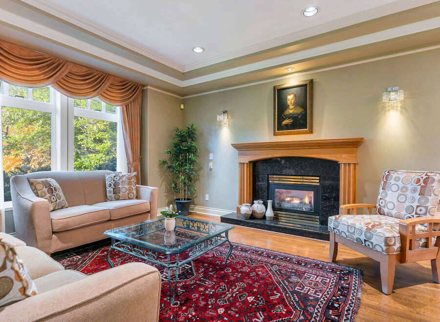 This elegant living room boasts a cozy fireplace, perfect for chilly evenings.