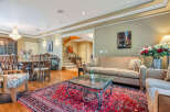 Step into luxury with this stunning property, showcasing a spacious living area perfect for entertaining.