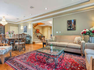Step into luxury with this stunning property, showcasing a spacious living area perfect for entertaining.