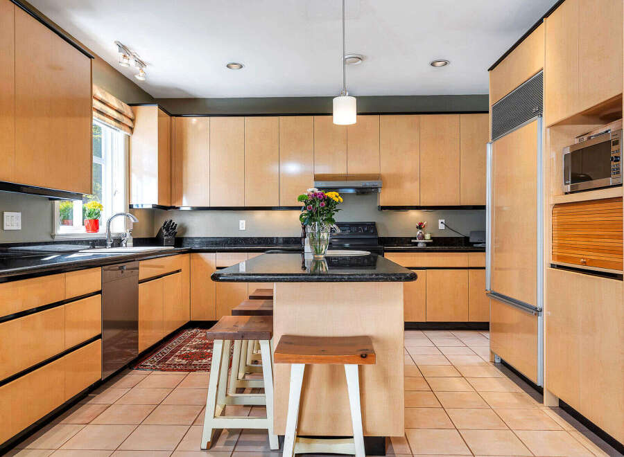 This stunning kitchen boasts sleek, modern cabinetry and a spacious layout, perfect for both cooking and entertaining.