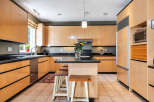 This stunning kitchen boasts sleek, modern cabinetry and a spacious layout, perfect for both cooking and entertaining.
