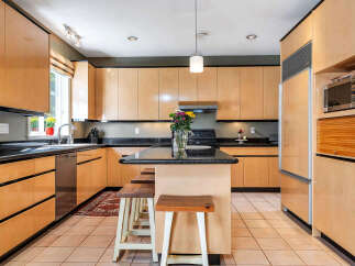 This stunning kitchen boasts sleek, modern cabinetry and a spacious layout, perfect for both cooking and entertaining.