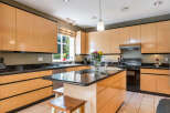 This stunning kitchen boasts sleek, modern cabinetry and a spacious layout, perfect for both cooking and entertaining.
