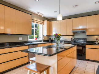 This stunning kitchen boasts sleek, modern cabinetry and a spacious layout, perfect for both cooking and entertaining.