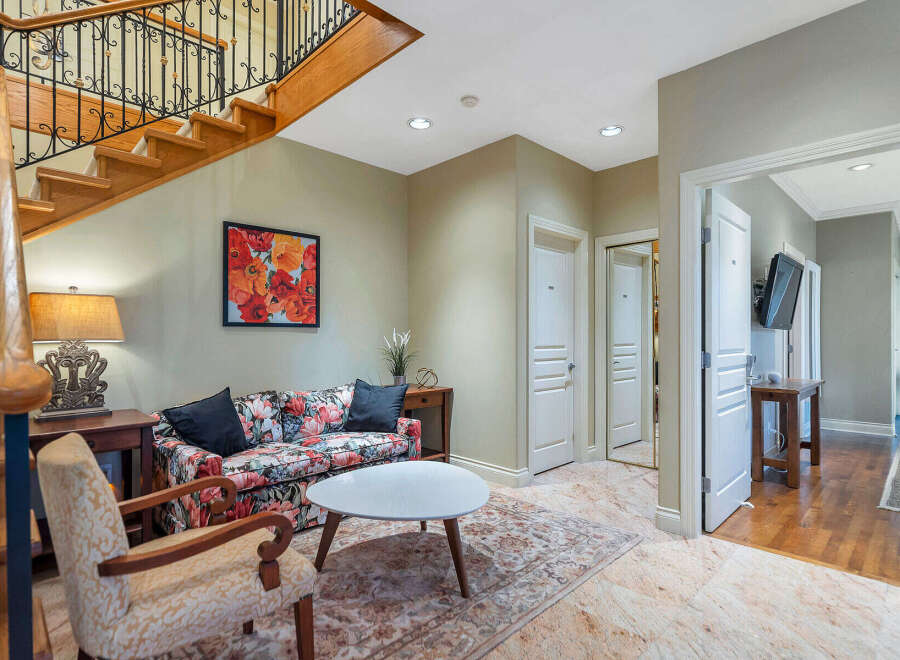 Step into luxury with this stunning property, featuring a grand staircase and elegant living spaces.