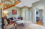 Step into luxury with this stunning property, featuring a grand staircase and elegant living spaces.