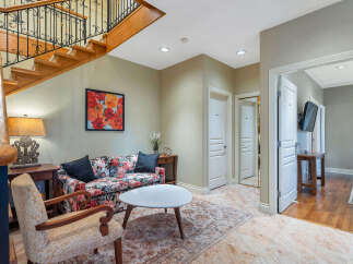 Step into luxury with this stunning property, featuring a grand staircase and elegant living spaces.