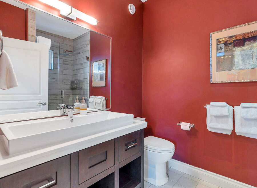 Step into luxury with this stunning bathroom! Featuring a sleek vanity, modern fixtures, and a vibrant accent wall, this space is designed for both style and functionality.