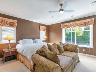 Step into luxury with this stunning bedroom! Featuring a comfortable bed, a stylish sofa, and elegant window treatments, this space is designed for relaxation.