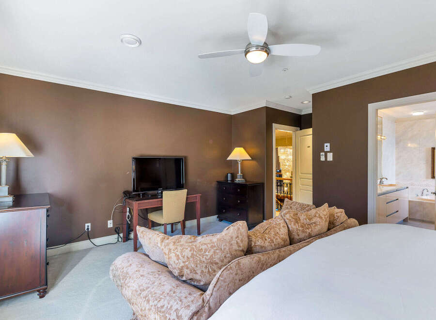 This luxurious bedroom boasts a sophisticated design with a focus on comfort and style.