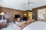 This luxurious bedroom boasts a sophisticated design with a focus on comfort and style.