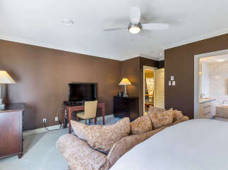 This luxurious bedroom boasts a sophisticated design with a focus on comfort and style.