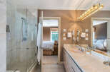Step into luxury with this stunning bathroom featuring a spacious glass shower and elegant marble countertops.