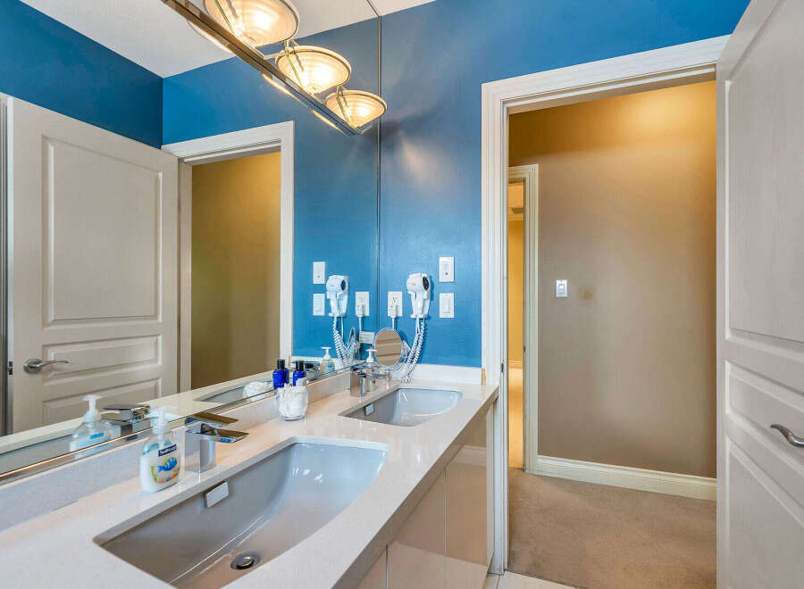 Step into luxury with this stunning bathroom featuring a sleek double vanity and a modern design.