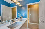 Step into luxury with this stunning bathroom featuring a sleek double vanity and a modern design.