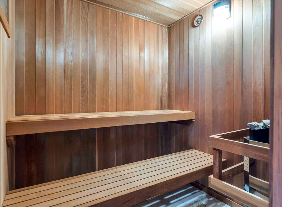 Step into your own private oasis with this stunning sauna! Featuring beautiful wood paneling and two-tiered seating, this space is perfect for relaxation and rejuvenation.