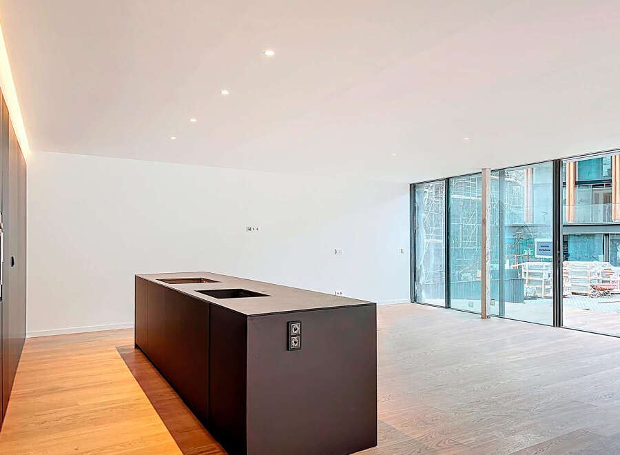 This modern kitchen boasts sleek design and ample space, perfect for culinary enthusiasts.