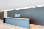 This modern kitchen boasts sleek, dark cabinetry and a spacious island, perfect for both cooking and entertaining.
