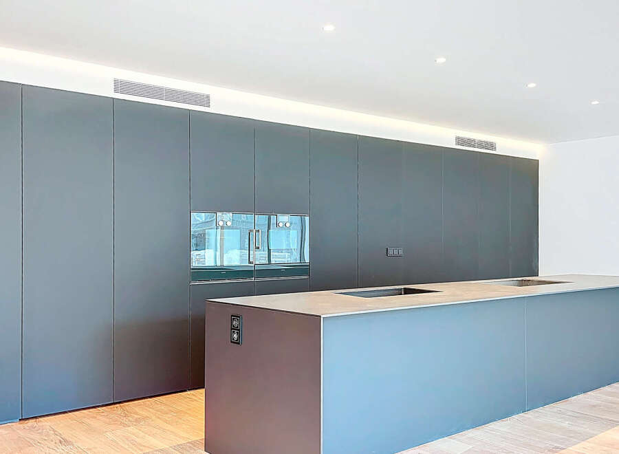 This modern kitchen boasts sleek, minimalist design with integrated appliances and ample storage.