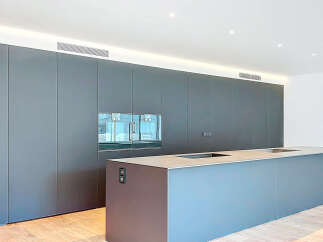 This modern kitchen boasts sleek, minimalist design with integrated appliances and ample storage.