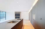 This modern kitchen boasts sleek, minimalist design with a large island and integrated appliances.