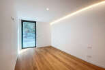 This modern space boasts a sleek design with clean lines and abundant natural light.
