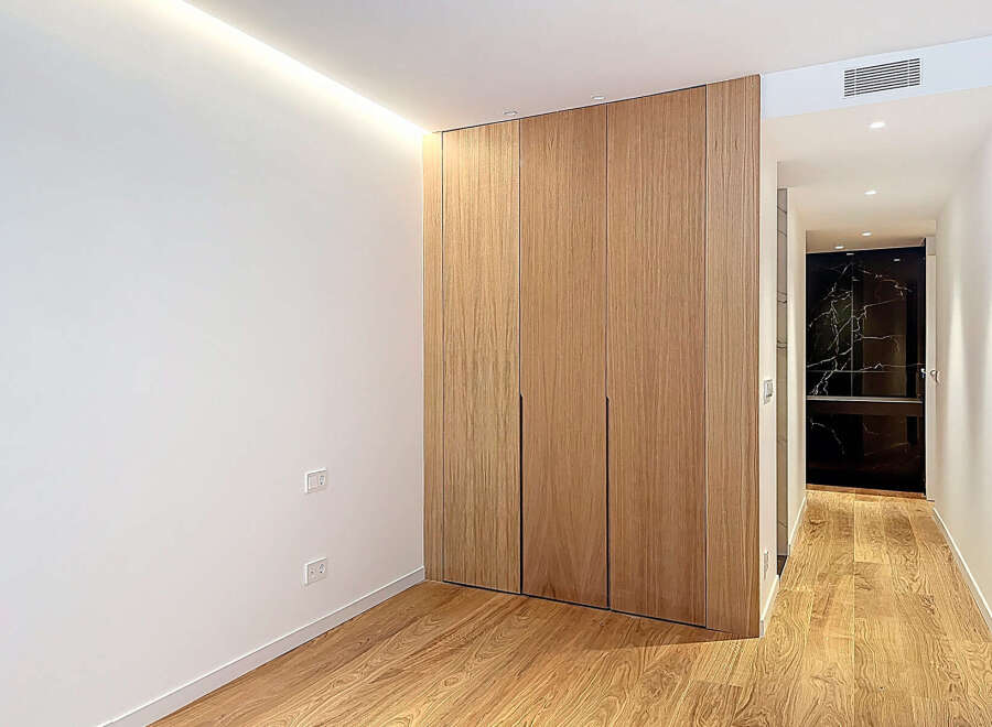 This stunning property features a modern design with sleek wooden cabinetry and flooring, creating a warm and inviting atmosphere.