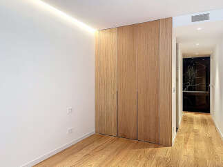 This stunning property features a modern design with sleek wooden cabinetry and flooring, creating a warm and inviting atmosphere.