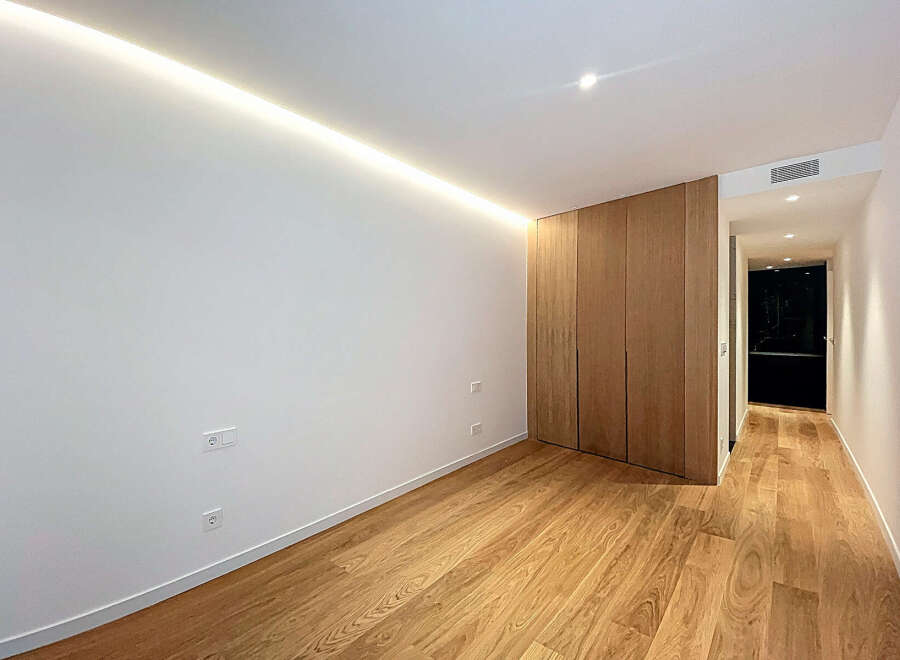 This modern space features a sleek design with hardwood flooring and a minimalist aesthetic.