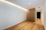 This modern space features a sleek design with hardwood flooring and a minimalist aesthetic.