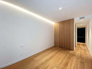 This modern space features a sleek design with hardwood flooring and a minimalist aesthetic.
