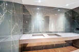 This luxurious bathroom boasts stunning marble walls and a sleek, modern design.