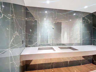 This luxurious bathroom boasts stunning marble walls and a sleek, modern design.