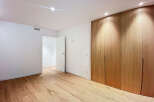 Step into this beautifully designed room featuring stunning wooden floors and a modern aesthetic.