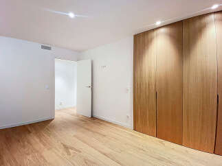 Step into this beautifully designed room featuring stunning wooden floors and a modern aesthetic.