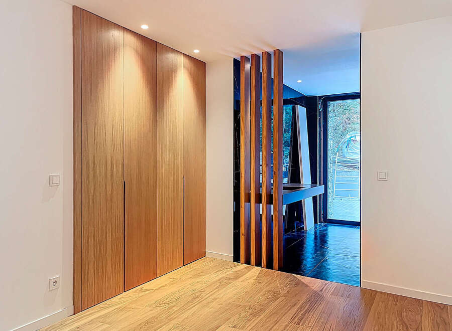This stunning property boasts a modern design with sleek wooden accents and ample natural light.