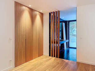 This stunning property boasts a modern design with sleek wooden accents and ample natural light.