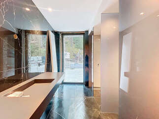 Experience luxury in this modern bathroom featuring stunning marble accents and a sleek, minimalist design.