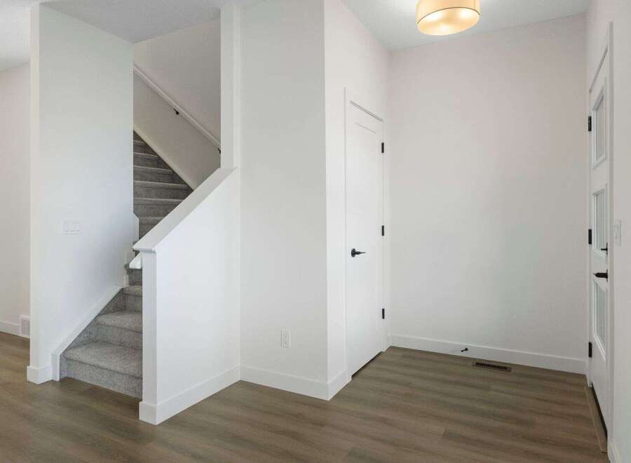 Step into this beautifully designed home featuring a modern staircase and a welcoming entryway.