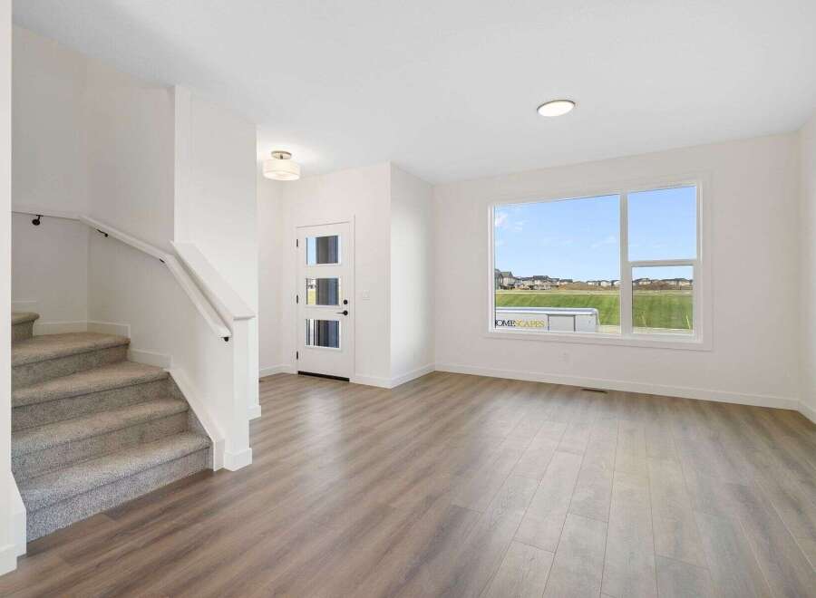 Step into this stunning home featuring a bright and airy living space with beautiful hardwood floors.
