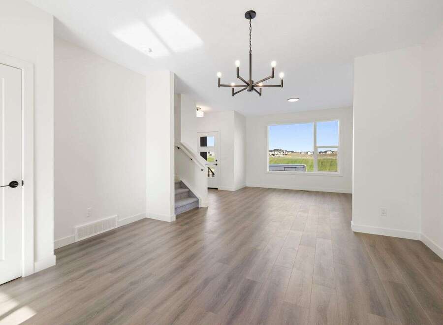 Step into this stunning home featuring a bright and airy living space with beautiful hardwood floors.