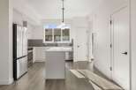 This stunning kitchen boasts a modern design with sleek white cabinetry and stainless steel appliances.