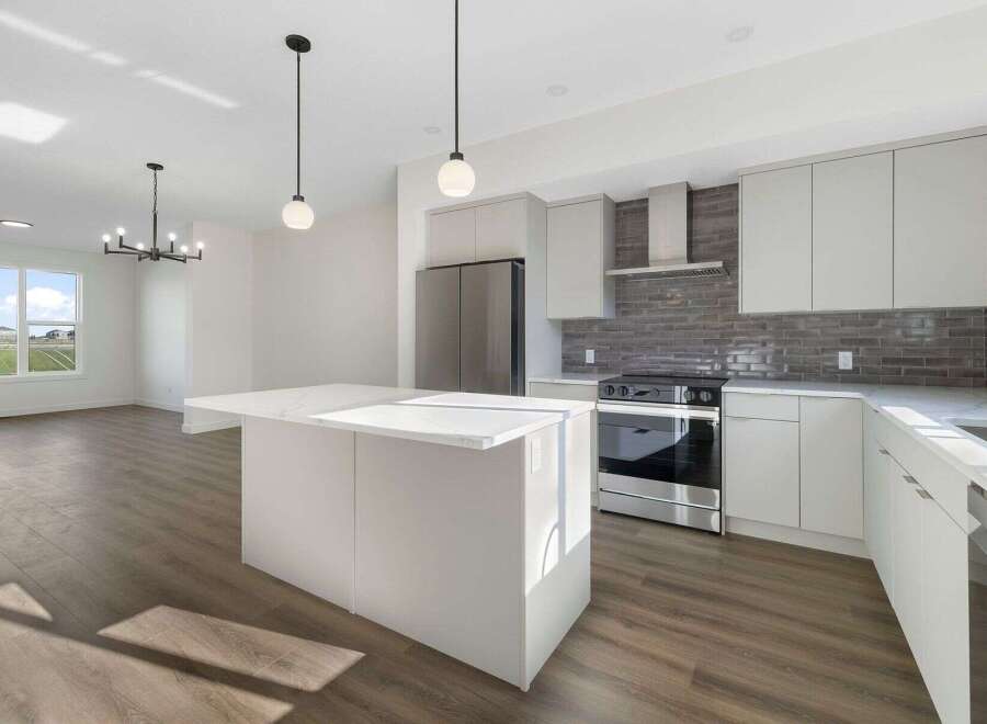 Step into modern elegance with this stunning kitchen! Featuring sleek white cabinetry, a spacious island, and stainless steel appliances, this space is perfect for both cooking and entertaining.