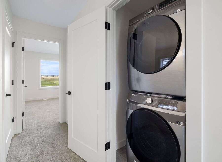 Discover the convenience of modern living with this stunning property! Featuring a dedicated laundry area with a sleek, stacked washer and dryer, making chores a breeze.