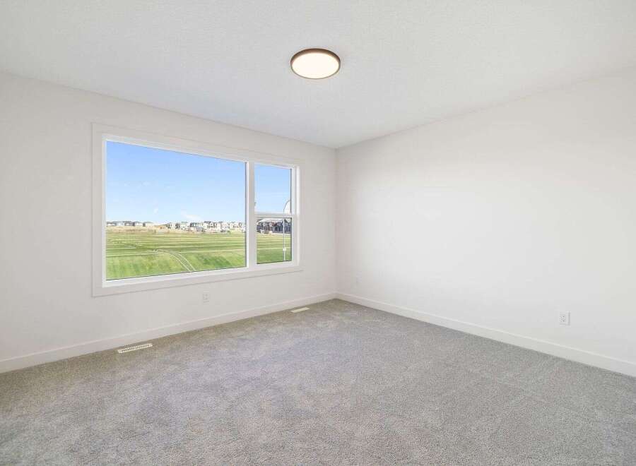 This bright and airy room features a large window that offers stunning views of the surrounding landscape.