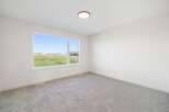 This bright and airy room features a large window that offers stunning views of the surrounding landscape.
