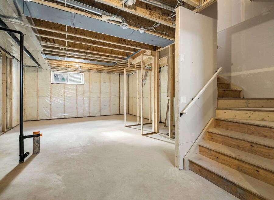 This unfinished basement offers a blank canvas for your dream living space.