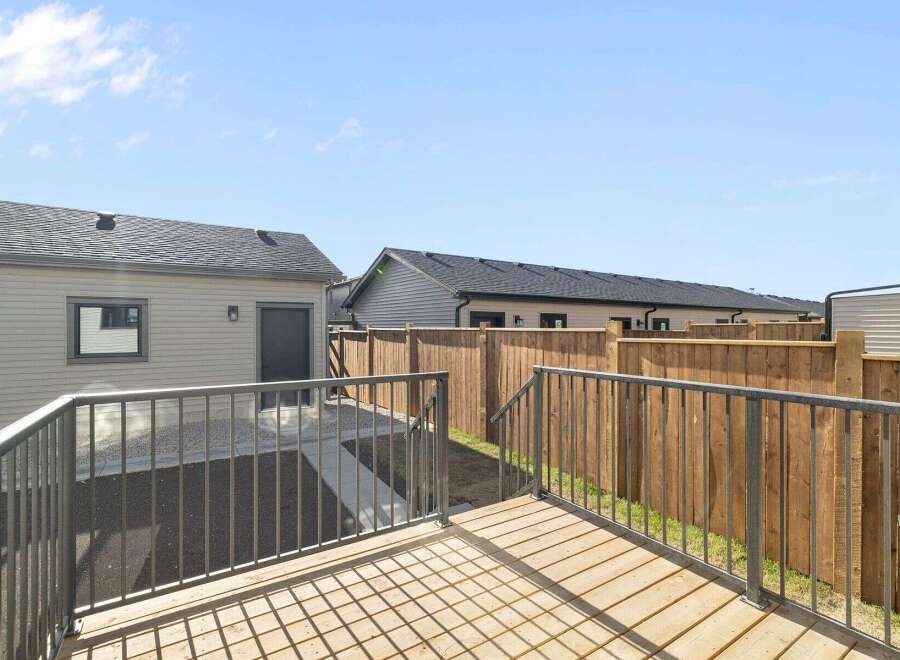 Enjoy outdoor living in this beautiful backyard! This property features a spacious deck, perfect for entertaining or relaxing.