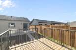 Enjoy outdoor living in this beautiful backyard! This property features a spacious deck, perfect for entertaining or relaxing.